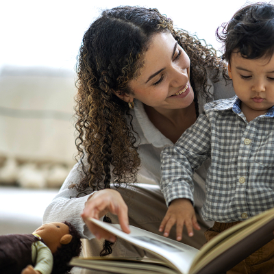 A woman and child reading a book 